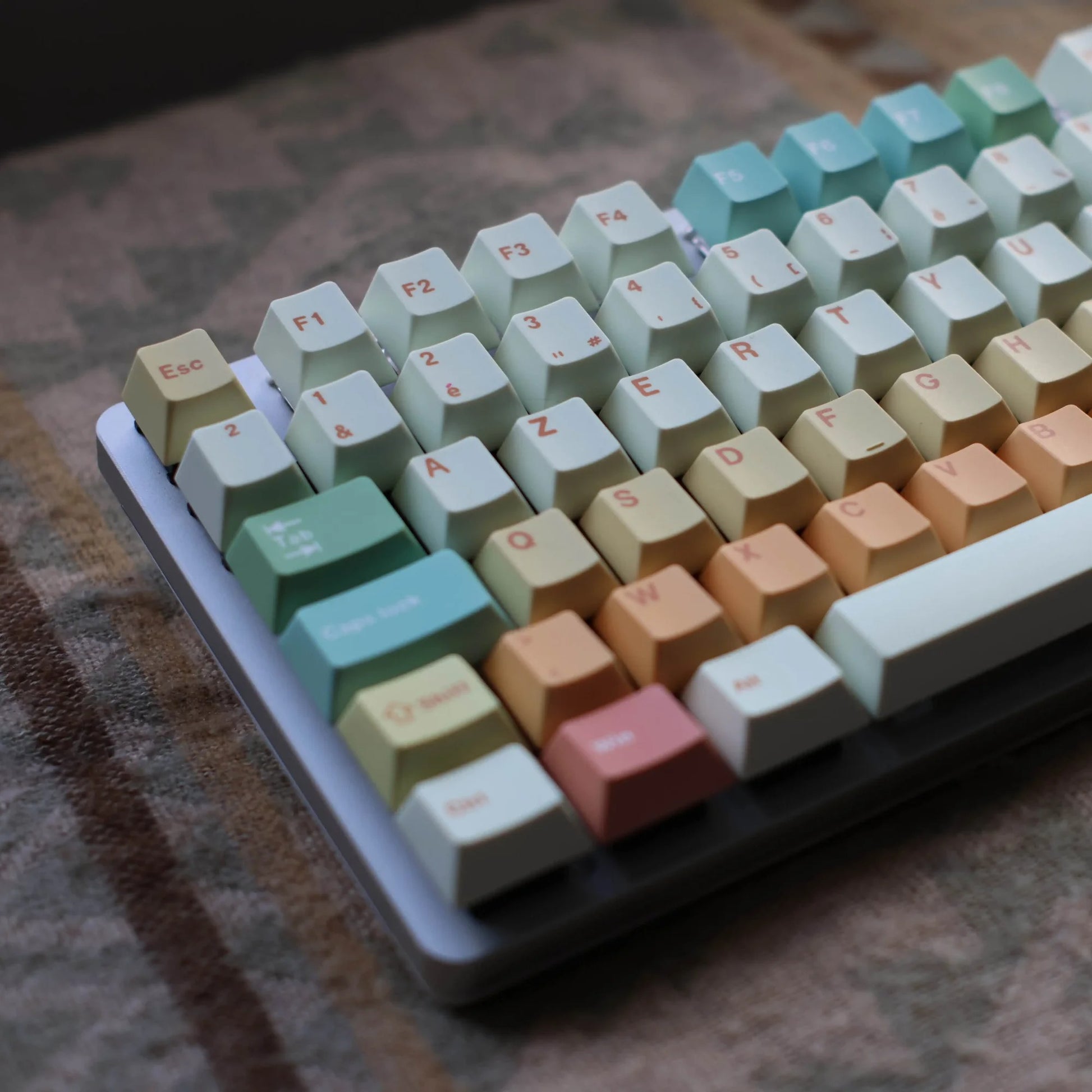 Colorful keyboard with pastel keycaps on a textured surface